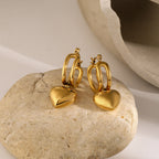 Gold heart studs on white background
