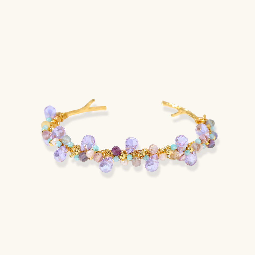 Fluorite and freshwater pearl gold-tone cuff bracelet on white background