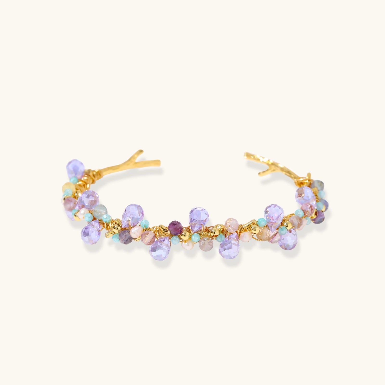 Fluorite and freshwater pearl gold-tone cuff bracelet on white background