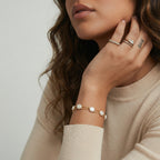 Baroque pearl layered bracelet on cream background