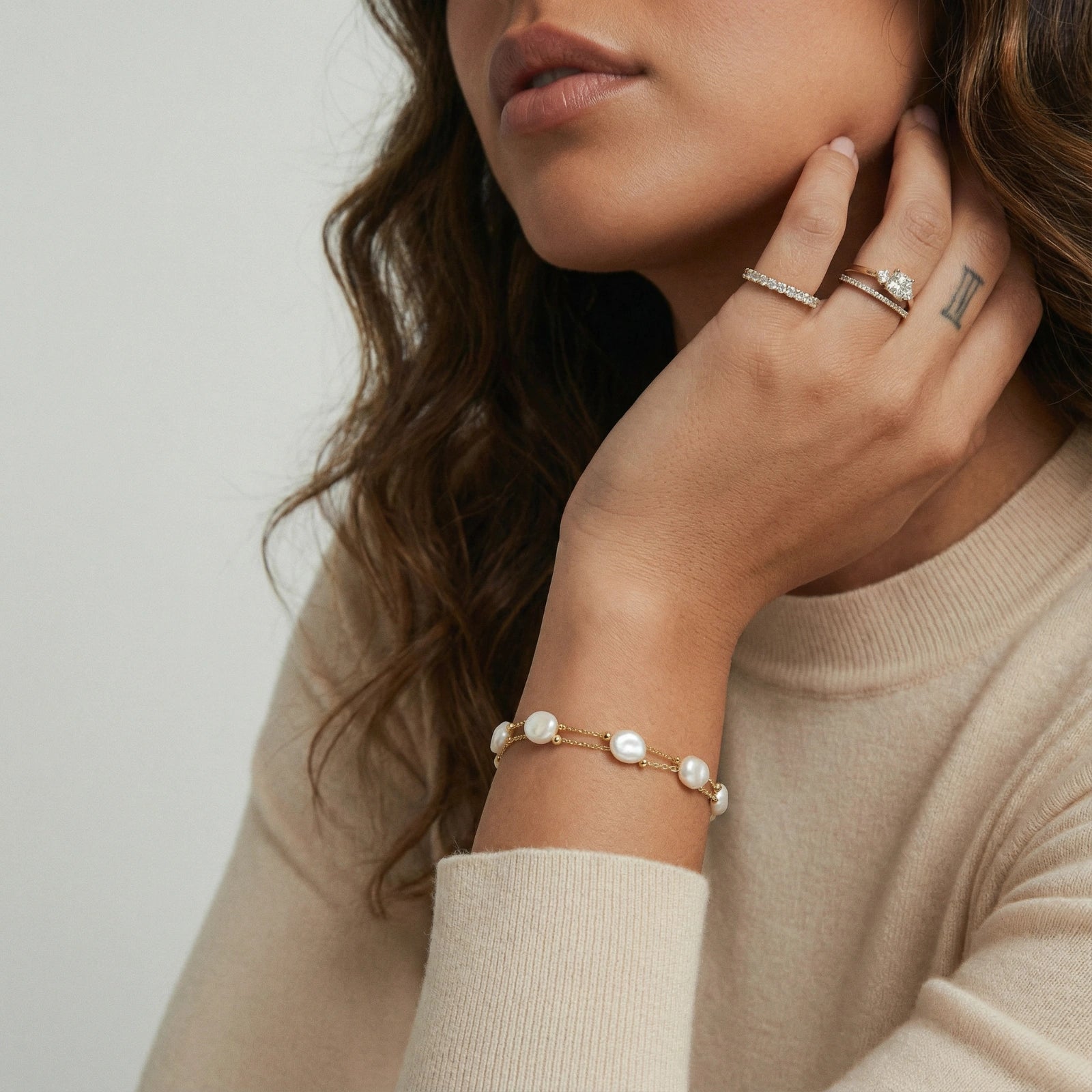 Baroque pearl layered bracelet on cream background