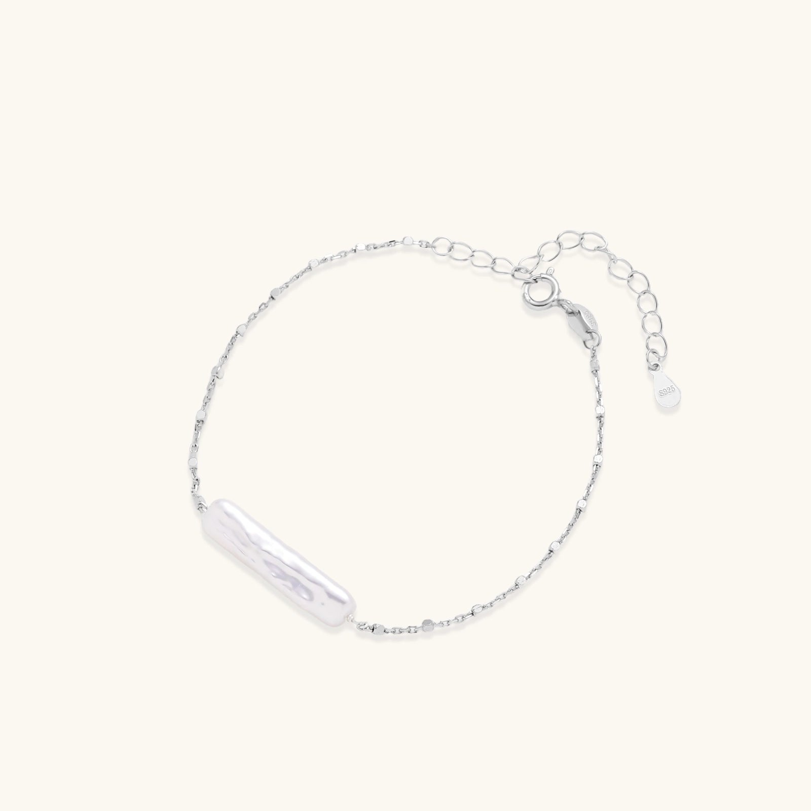 Baroque pearl chain bracelet in silver-tone on cream background
