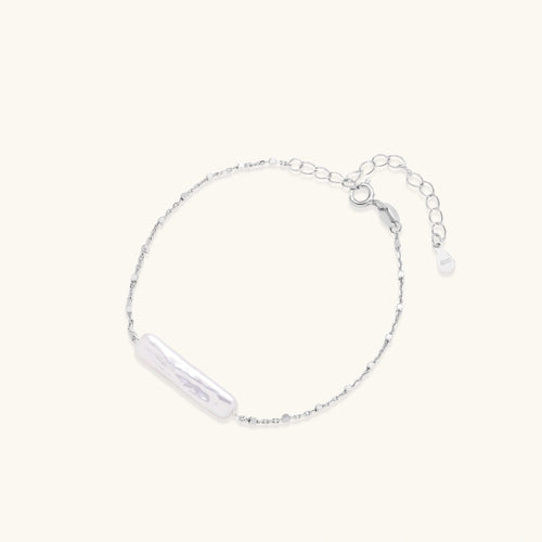 Baroque pearl chain bracelet in silver-tone on cream background