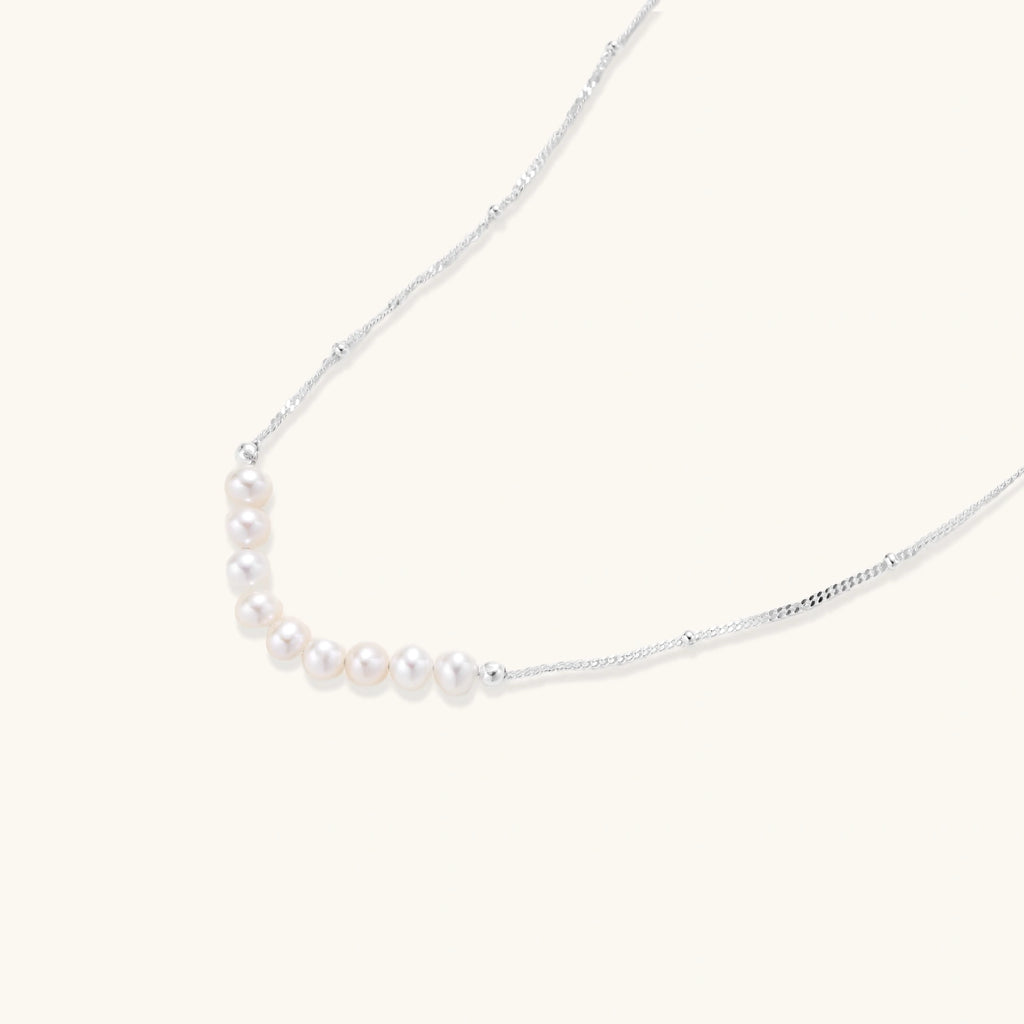 Silver-tone freshwater pearl arc necklace close-up