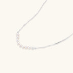 Silver-tone freshwater pearl arc necklace close-up