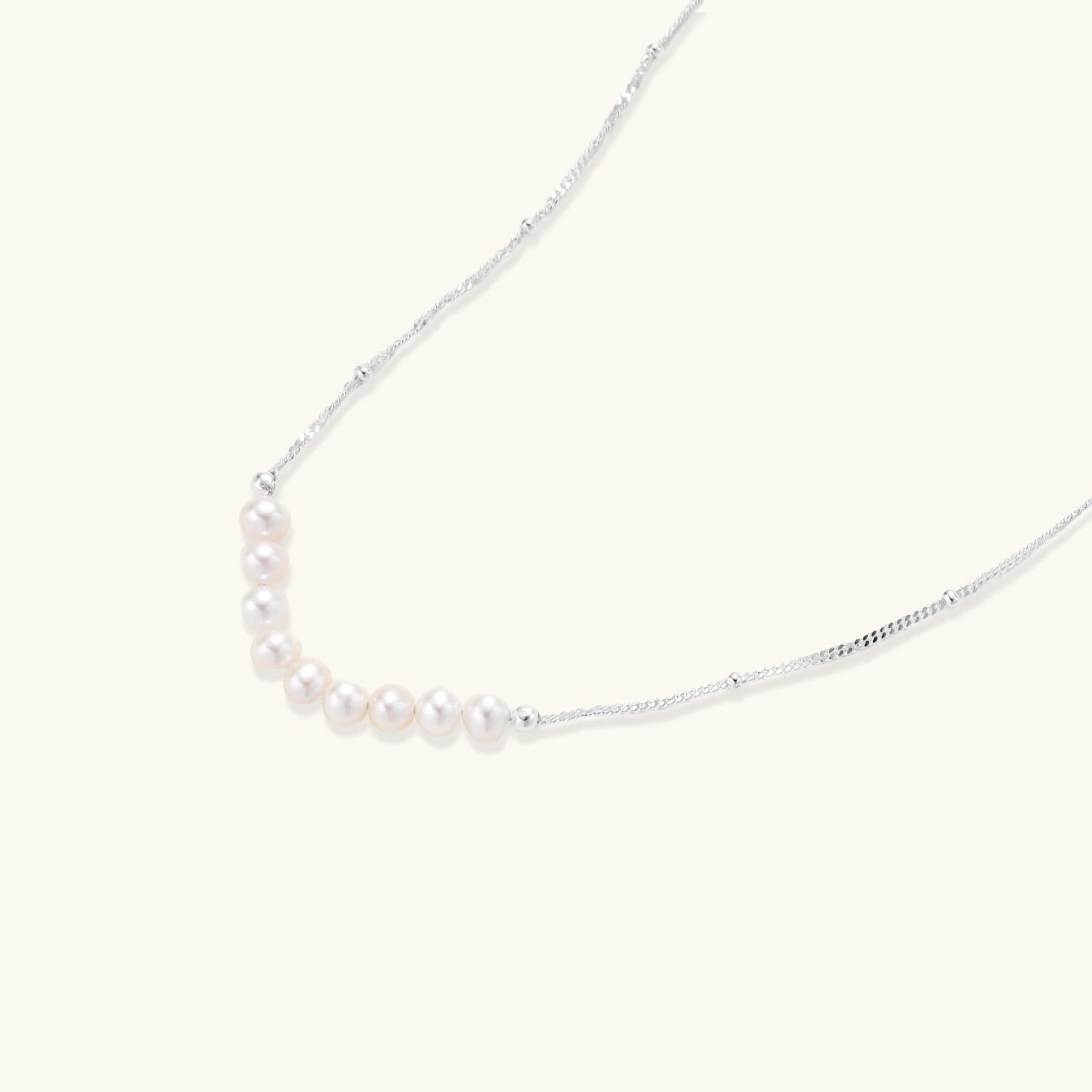 Silver-tone freshwater pearl arc necklace close-up
