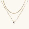 Gold-tone dual-chain layered necklace with crystal accent