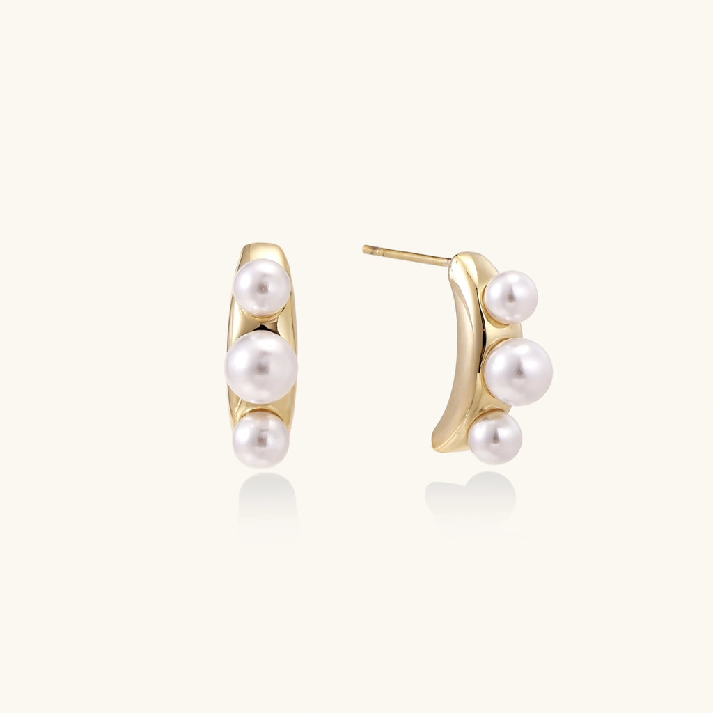 Pearl trio curve studs in gold-tone on cream background