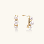 Pearl trio curve studs in gold-tone on cream background