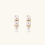 Gold-tone pearl climber studs close-up