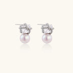 Stardust pearl drop earrings in silver-tone on white background
