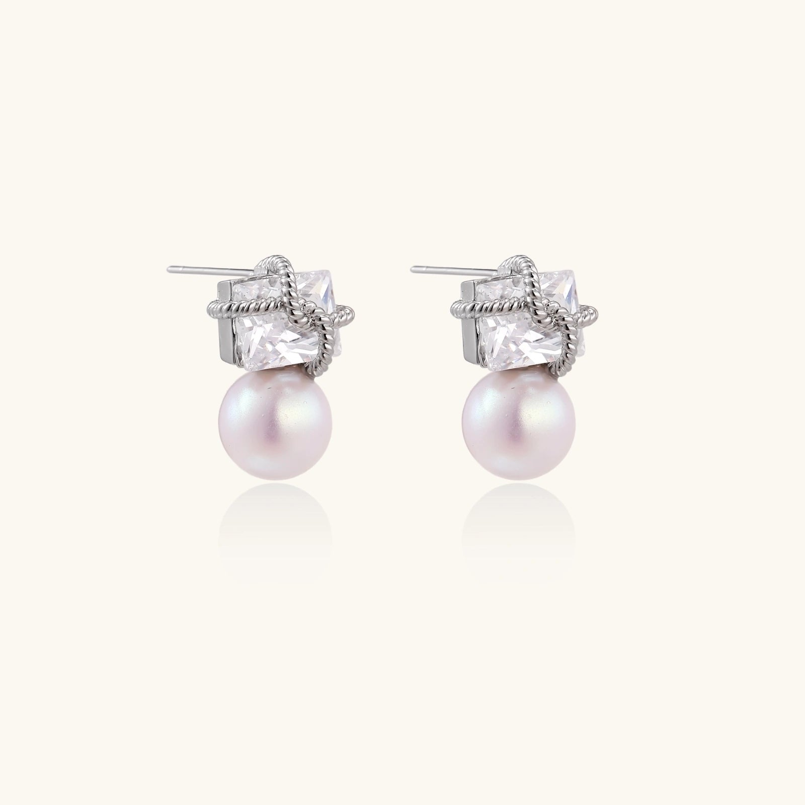 Stardust pearl drop earrings in silver-tone on white background