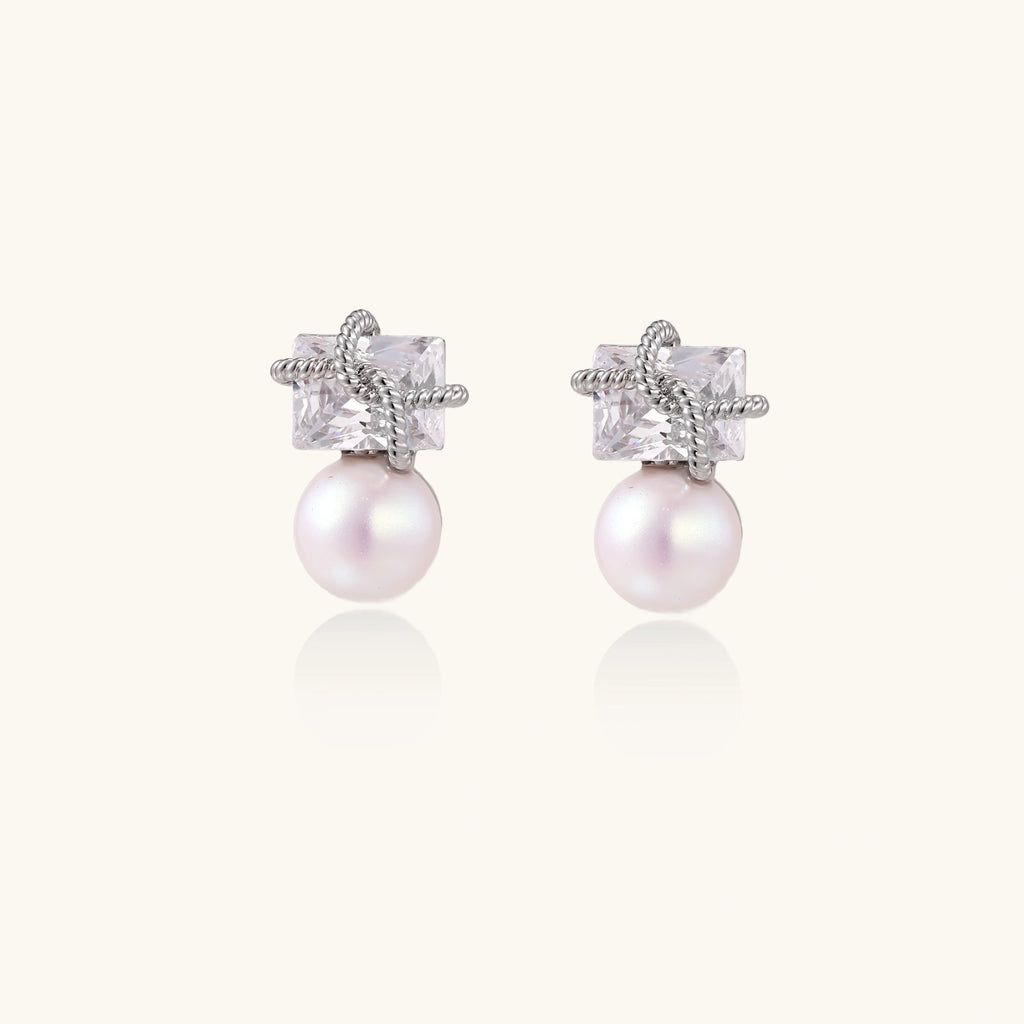Silver-tone crystal and pearl drop earrings close-up