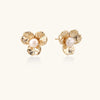 Bloom pearl flower studs in gold-tone on beige background