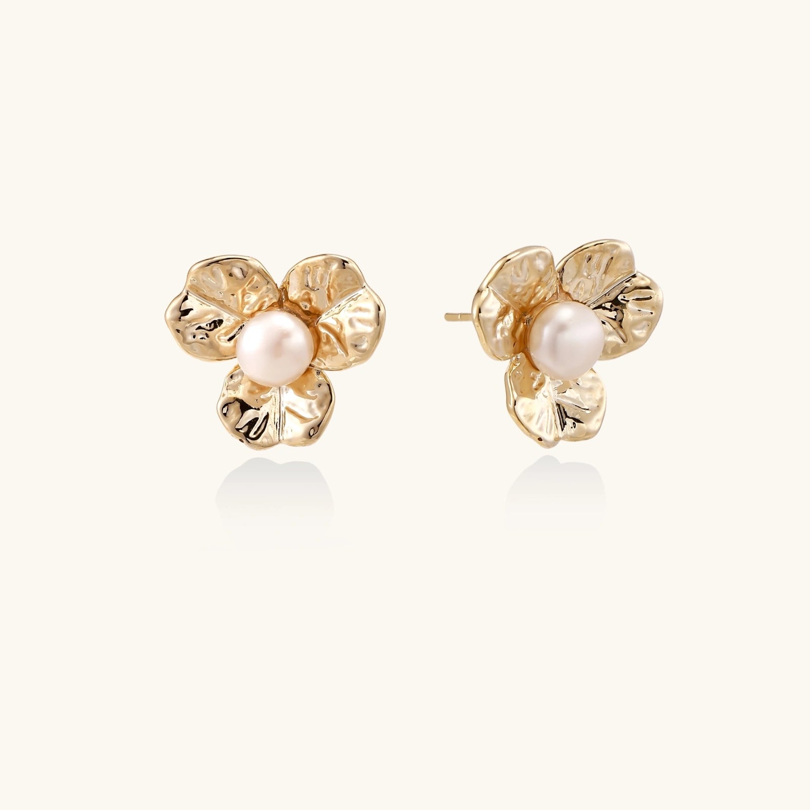 Bloom pearl flower studs in gold-tone on beige background