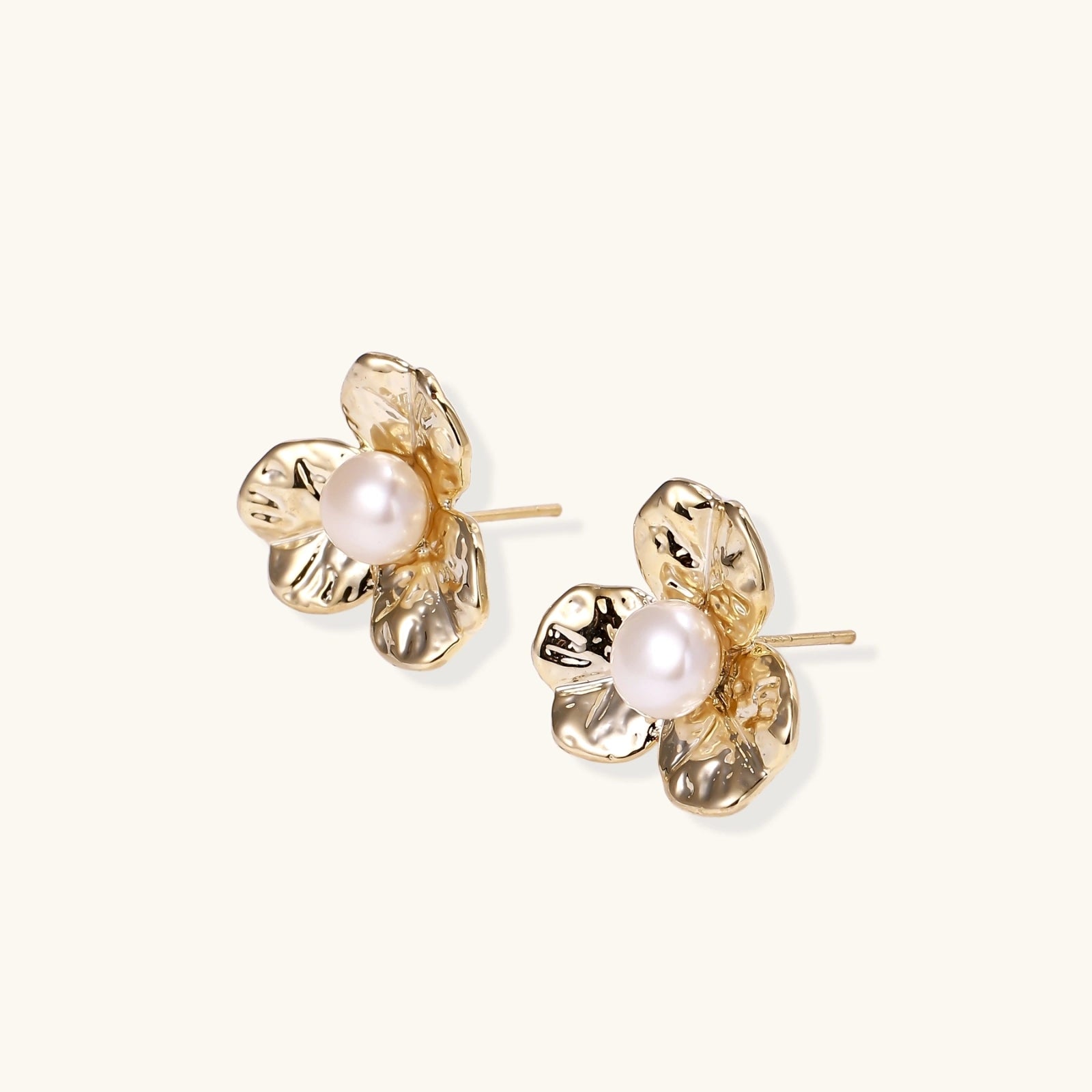 Gold-tone flower stud earrings close-up
