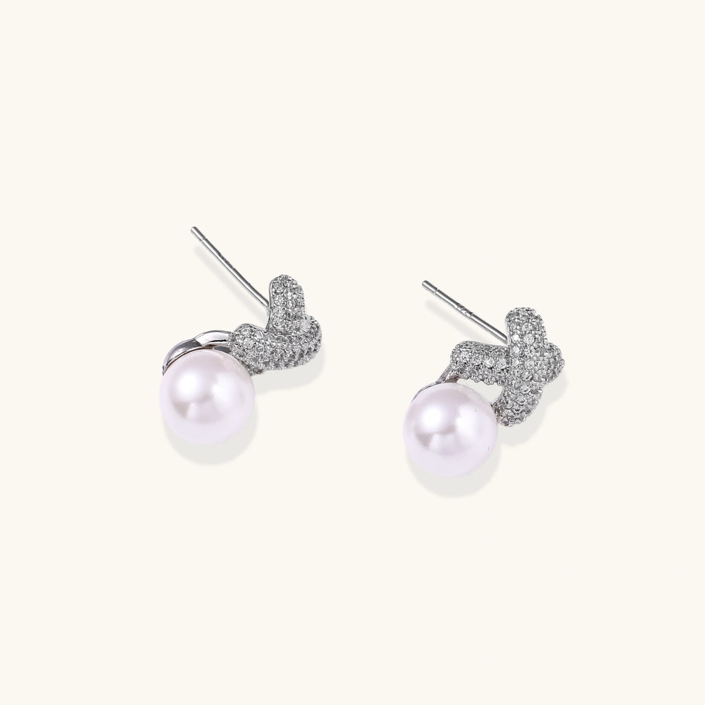 Pavé crystal and pearl stud earrings detail