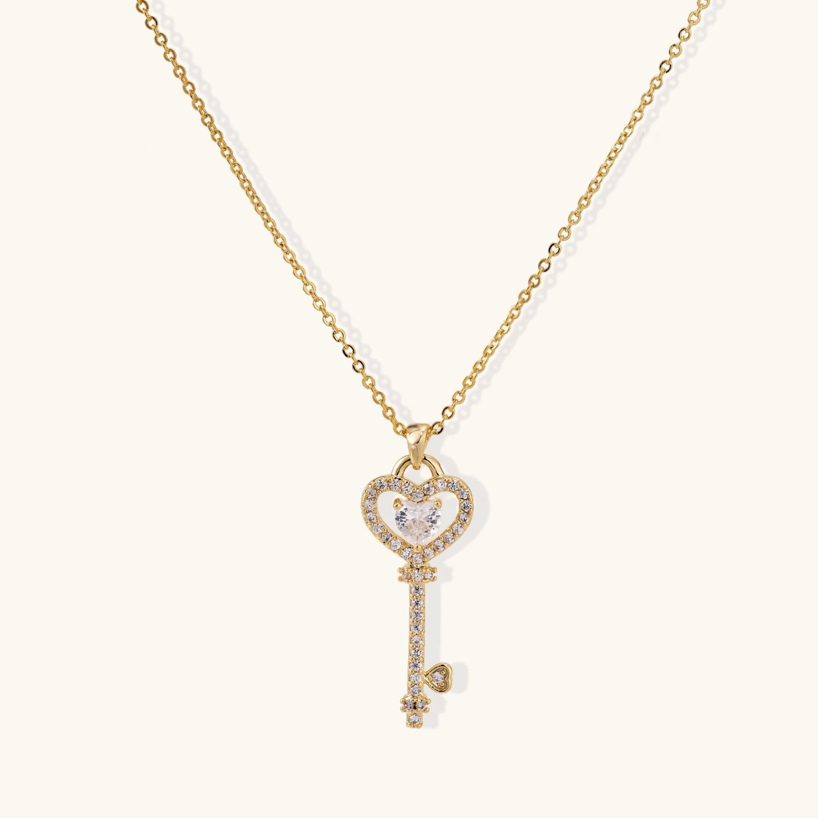 Secret heart key necklace in gold-tone on cream background