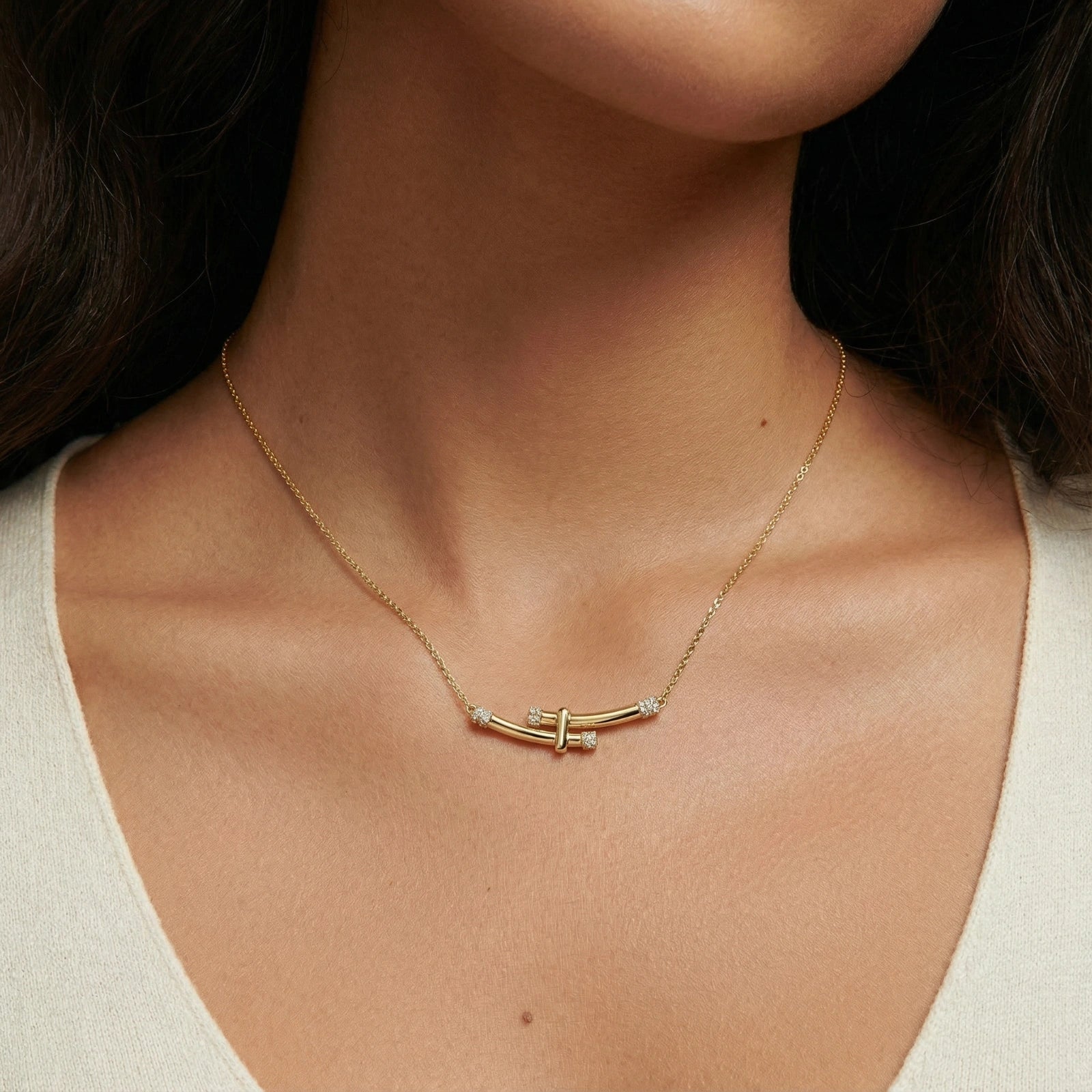 Crystal arc necklace on cream background