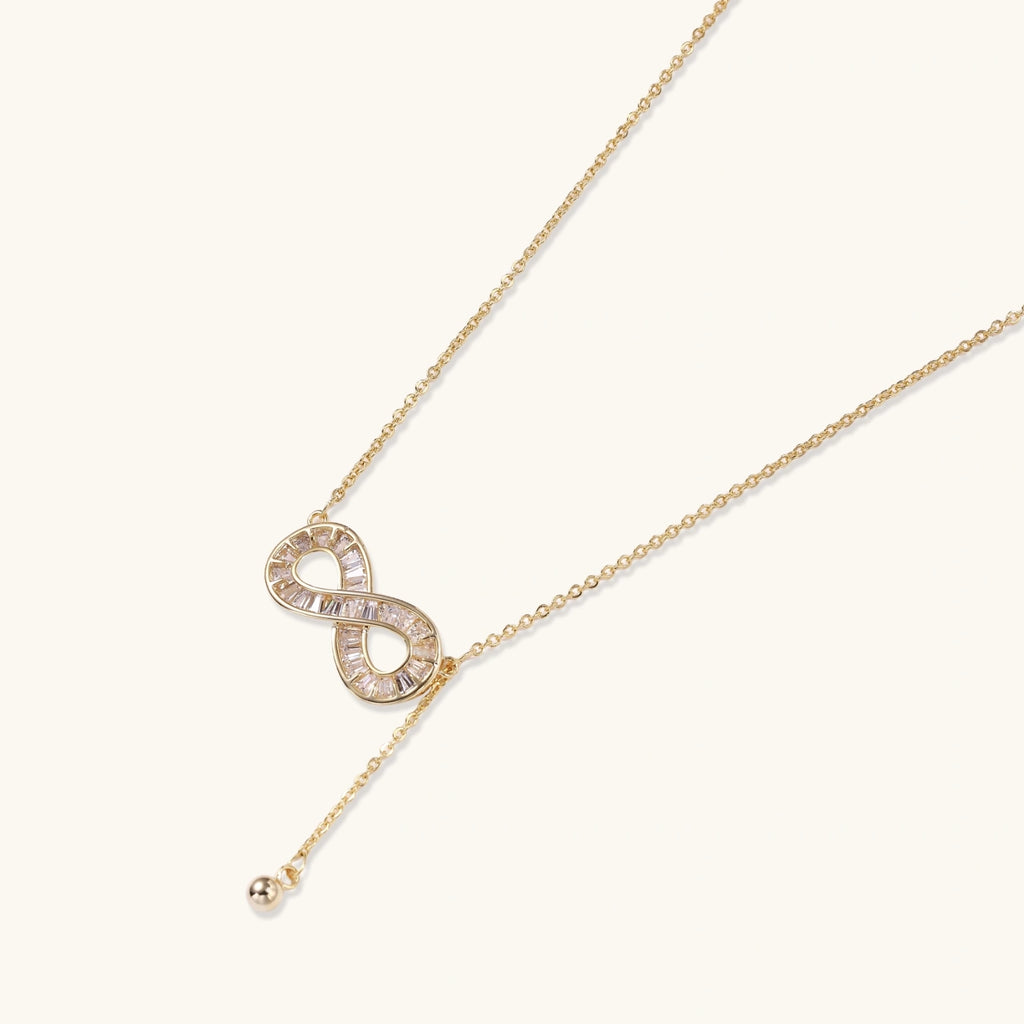 Gold-tone infinity crystal pendant close-up