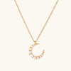 Gold-tone crescent moon necklace with graduated shell pearls