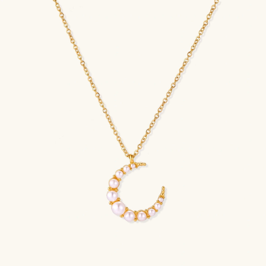 Gold-tone crescent moon necklace with graduated shell pearls