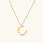 Gold-tone crescent moon necklace with graduated shell pearls