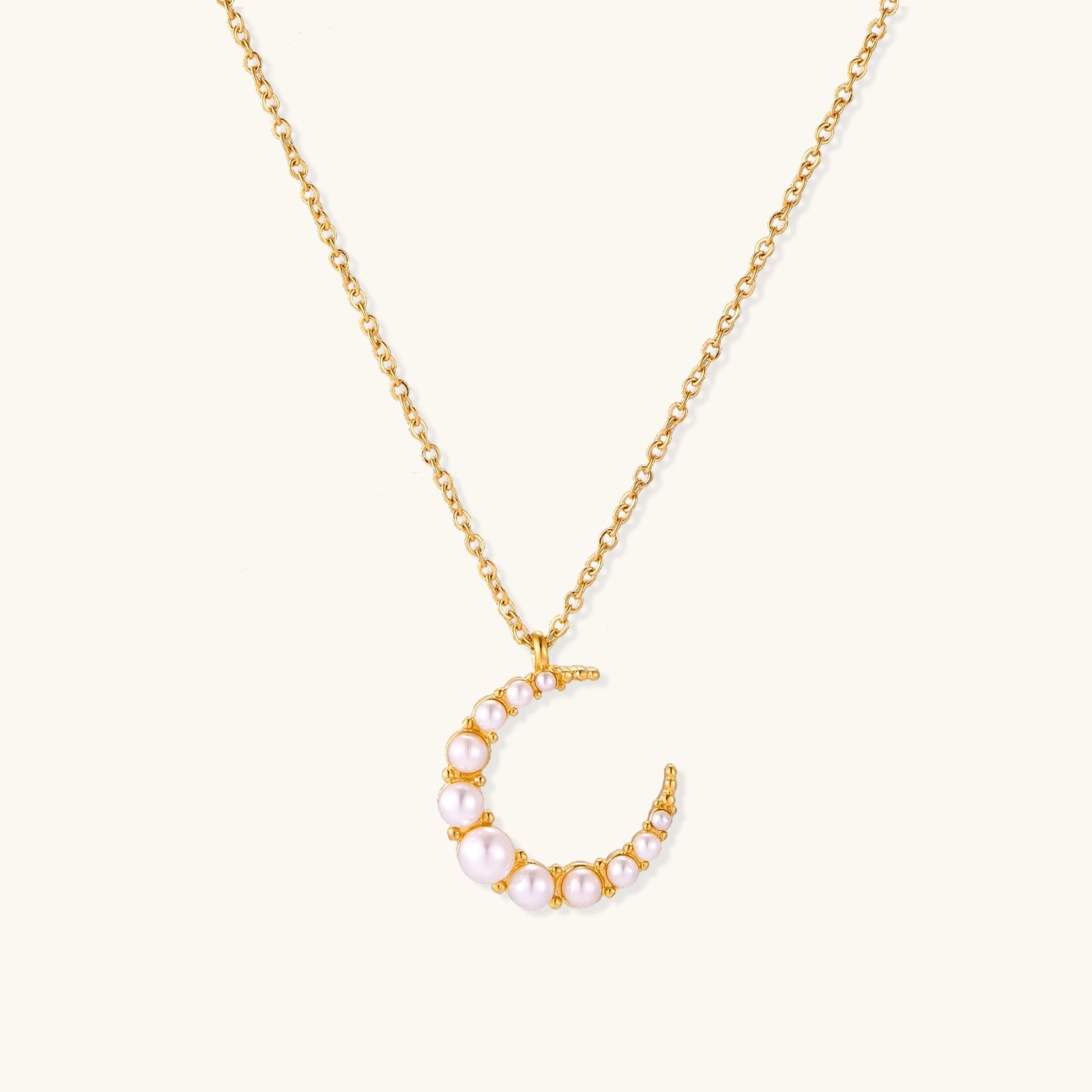 Gold-tone crescent moon necklace with graduated shell pearls