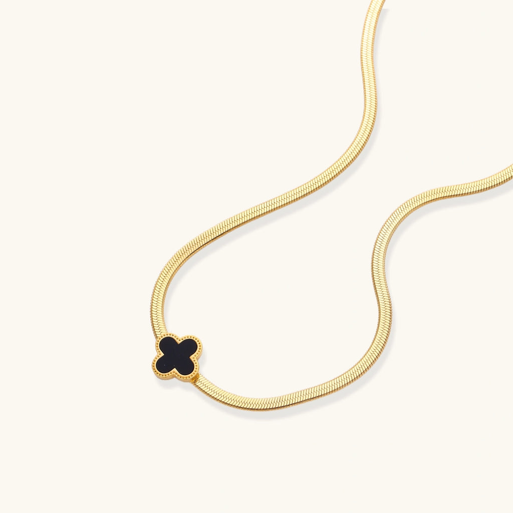 Black enamel quatrefoil clover pendant close-up