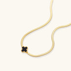 Black enamel quatrefoil clover pendant close-up
