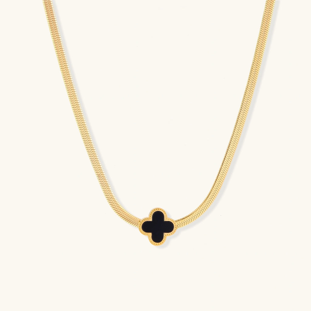 Gold-tone herringbone necklace with black enamel clover