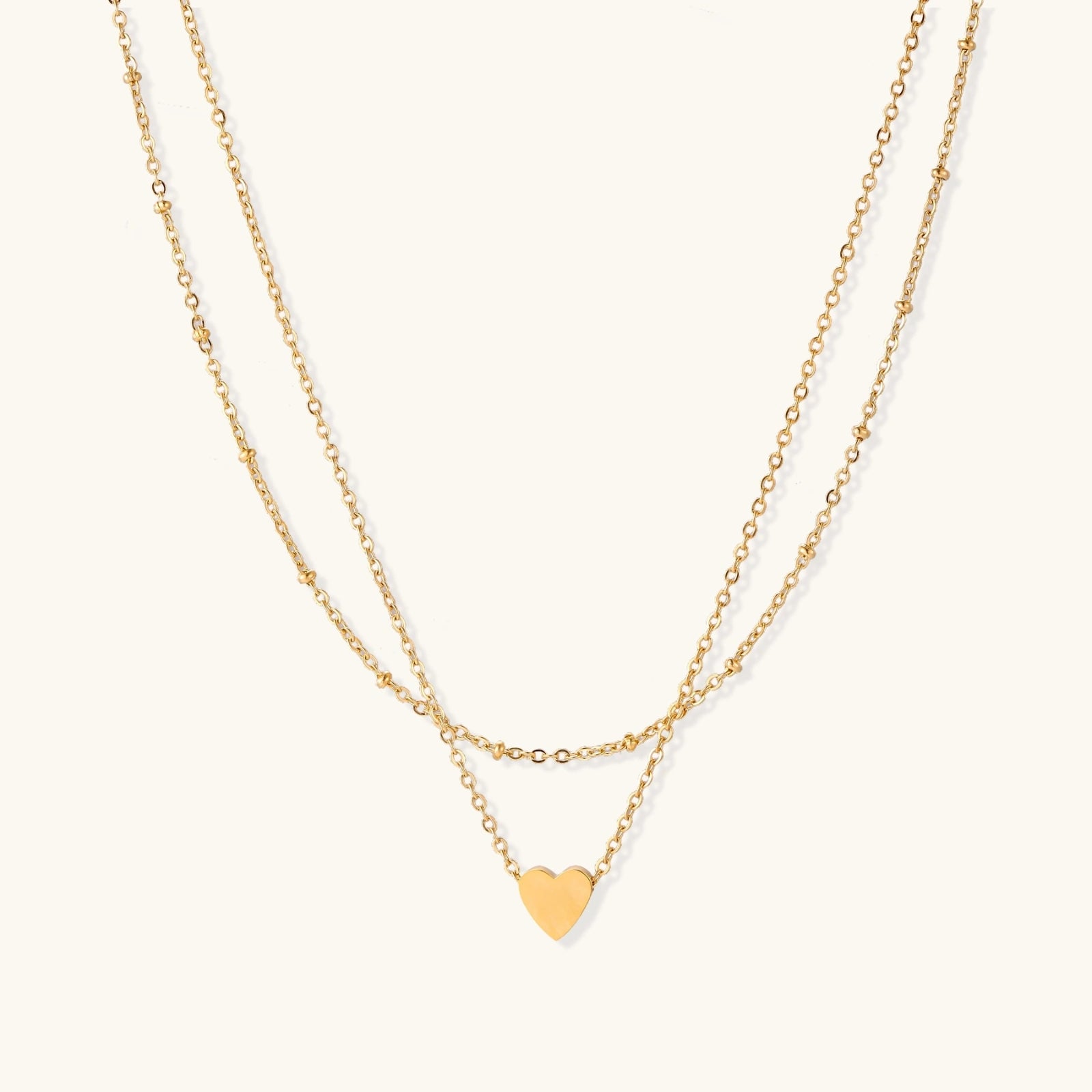 Gold-tone layered heart necklace on white background