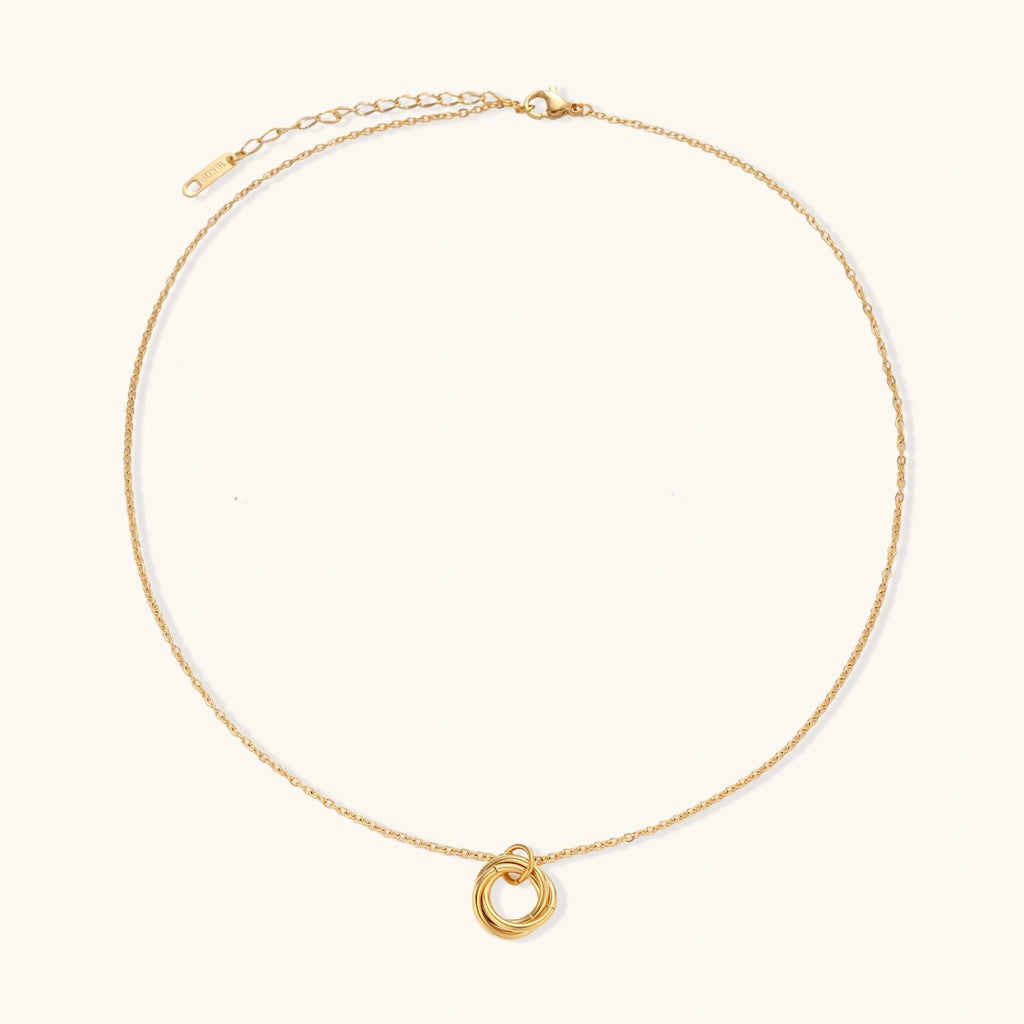 Gold-tone knot necklace on white background