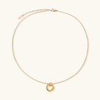 Gold-tone knot necklace on white background