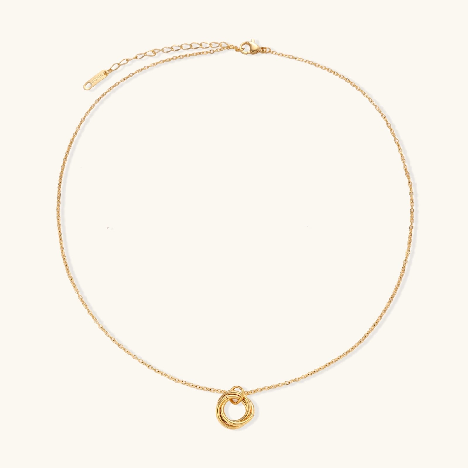 Gold-tone knot necklace on white background