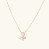 Gold-tone mother-of-pearl butterfly necklace on white background