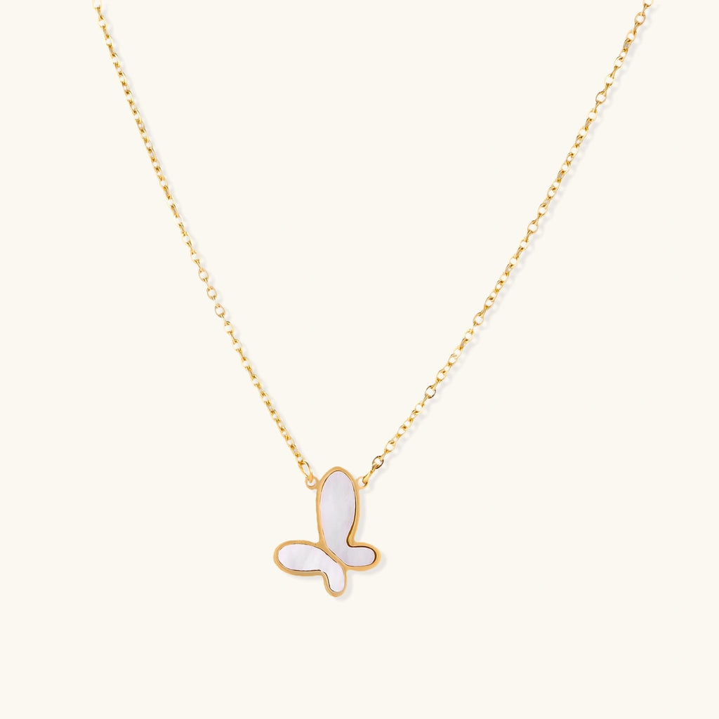 Gold-tone mother-of-pearl butterfly necklace on white background