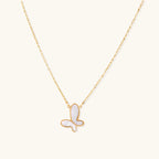 Gold-tone mother-of-pearl butterfly necklace on white background