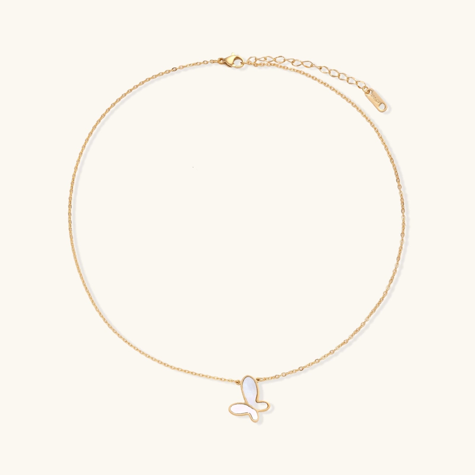 Gold-tone butterfly necklace shown on model