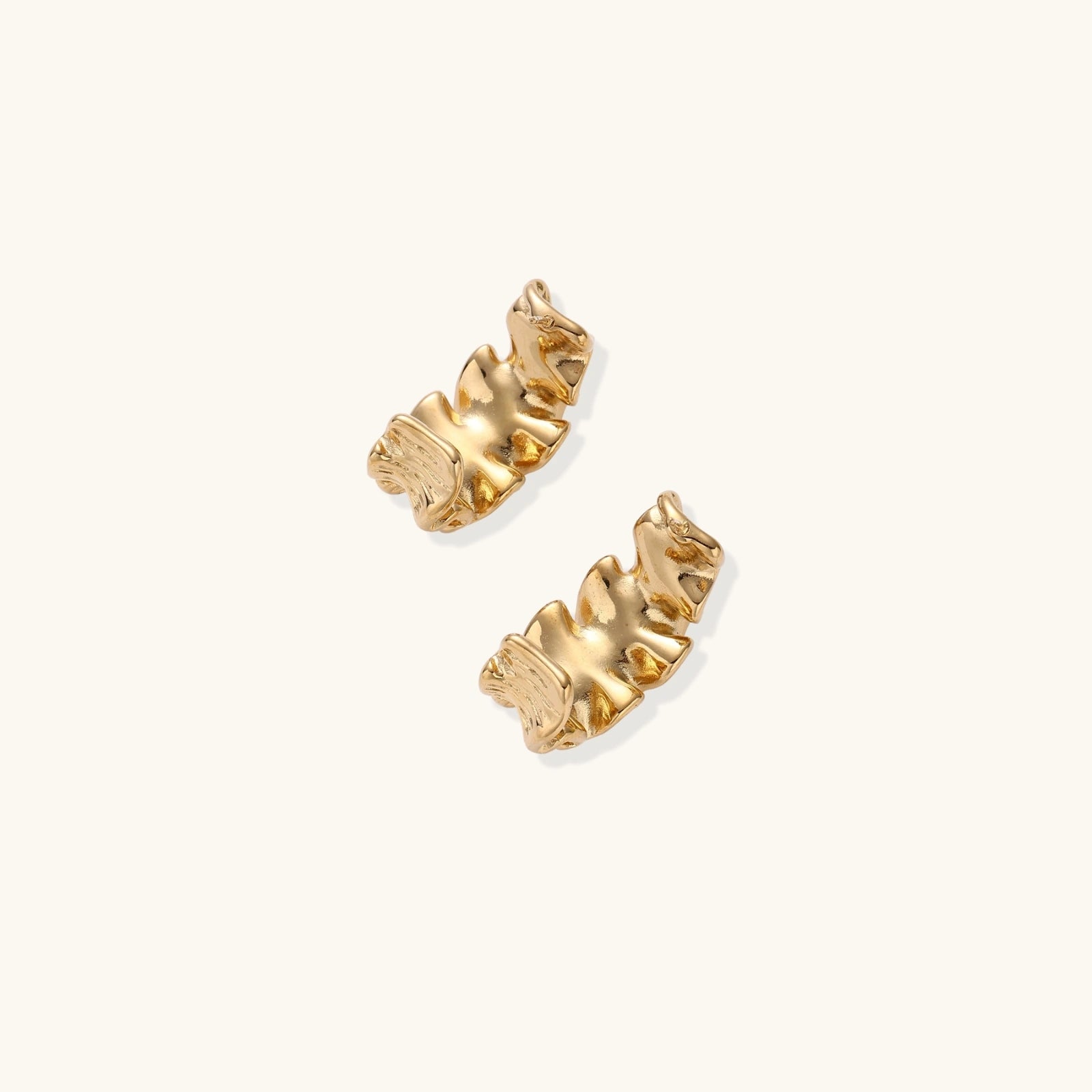 Gold-tone sculptural wave hoops side view