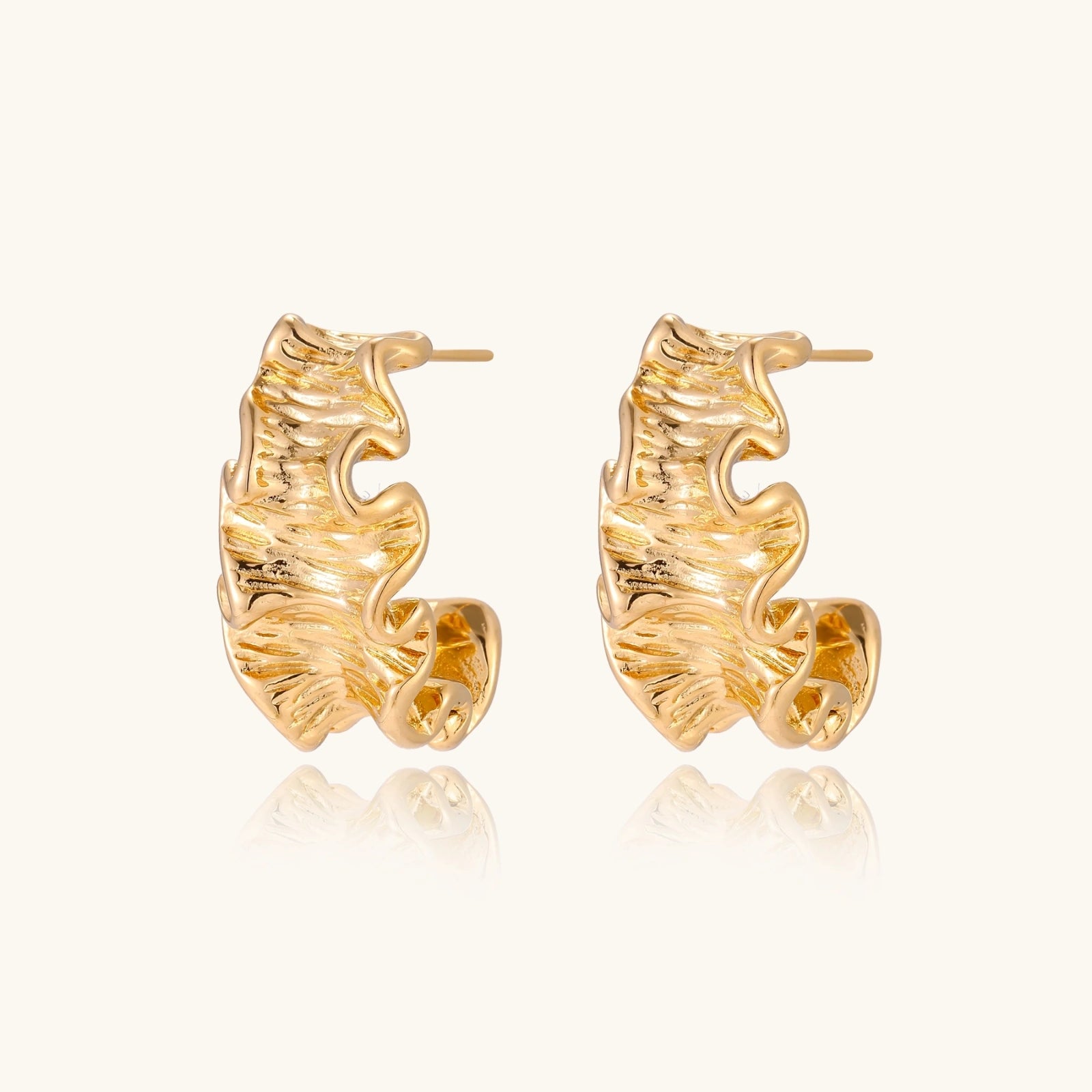 Gold-tone wave hoop earrings detail
