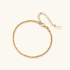 Gold-tone chain bracelet on white background