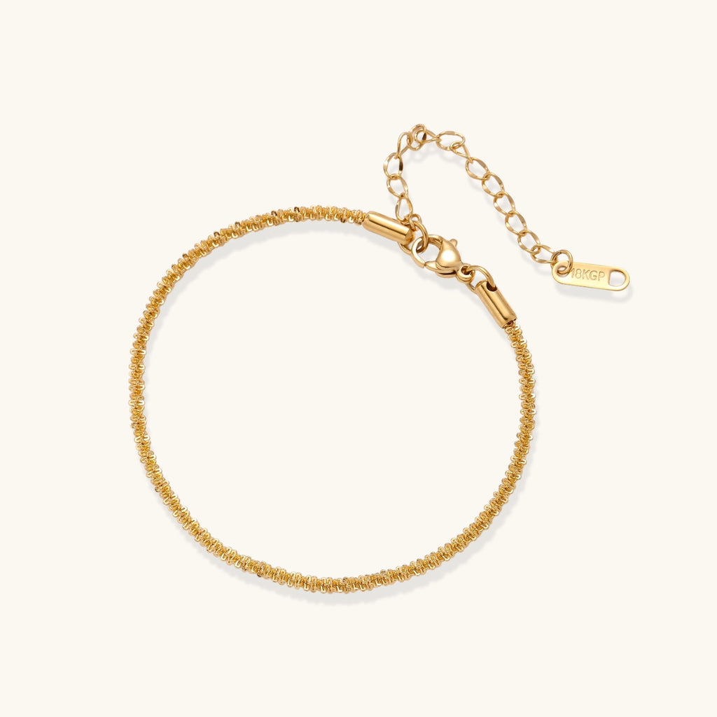 Gold-tone chain bracelet on white background