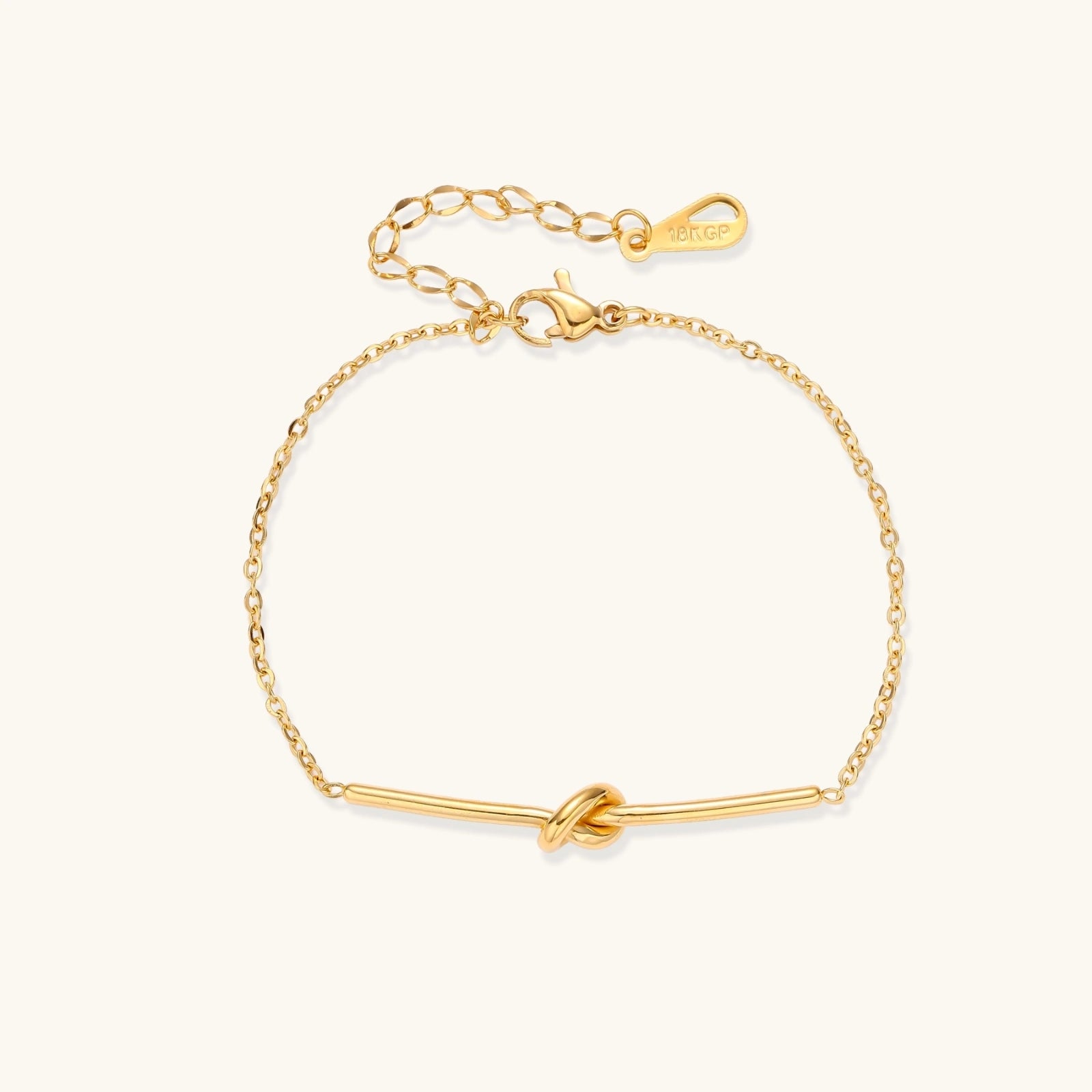 Gold-tone knot bar bracelet on white background