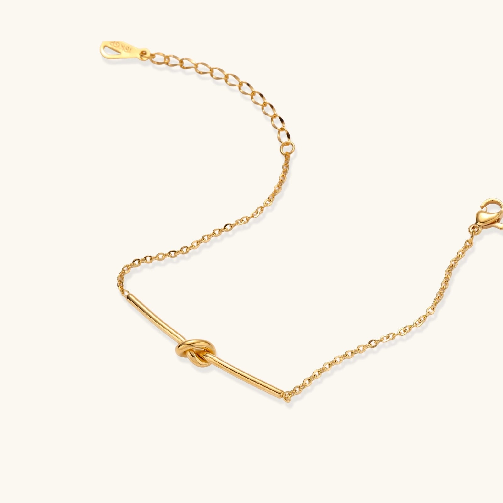 Gold-tone knot bar bracelet close-up of the knot detail