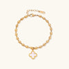 Gold-tone beaded clover bracelet with mother-of-pearl inlay on cream background