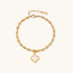 Gold-tone beaded clover bracelet with mother-of-pearl inlay on cream background
