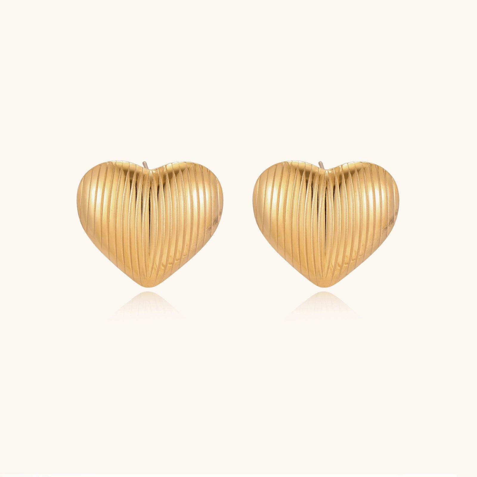Textured heart stud earrings close-up detail