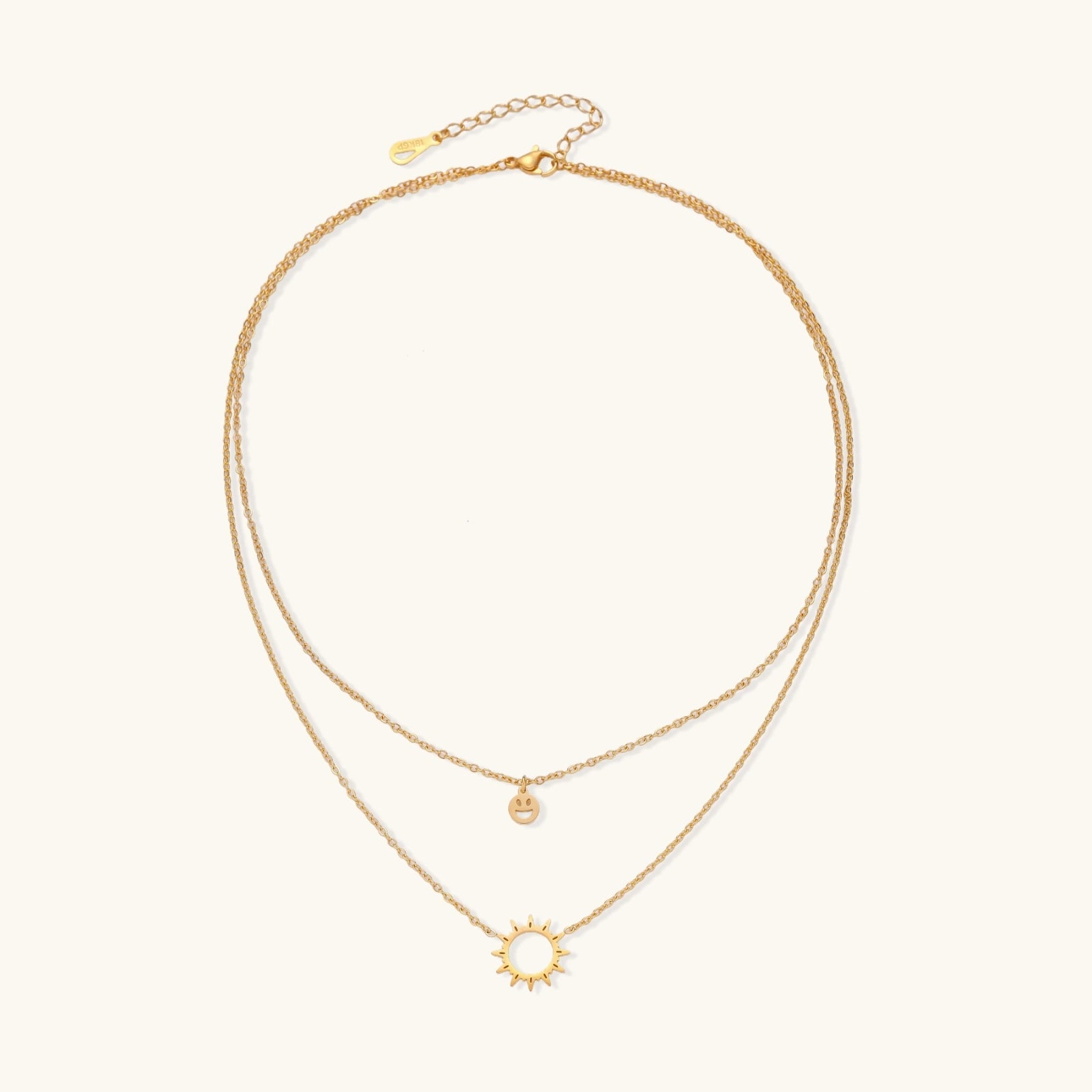 Layered gold-tone charm necklace detail