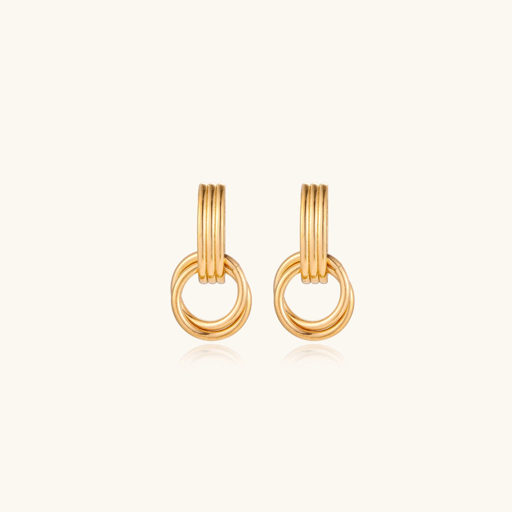 Triple ring gold-tone drop earrings close-up